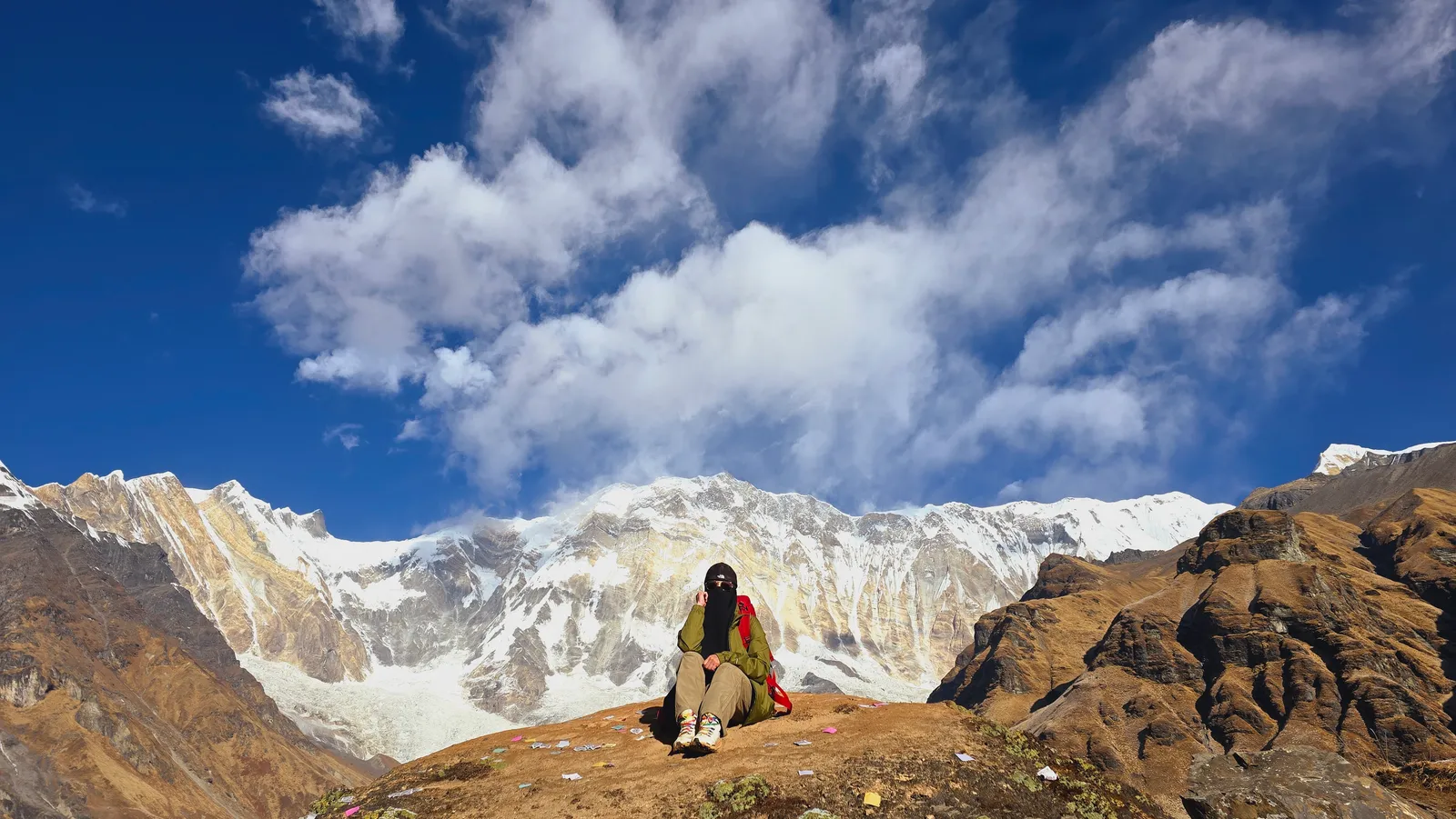 A tired trekker resting on the Annapurna Base Camp trail